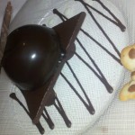 Bittersweet chocolate mousse on a chocolate platform topped with a hazelnut butterfly