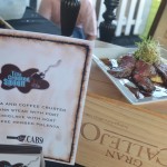 The Crooked Spoon - Cocoa & Coffee Crusted Flank Steak on a Bed of Goat Cheese Stone Ground Grits, dressed with a Port Demi-Glace.